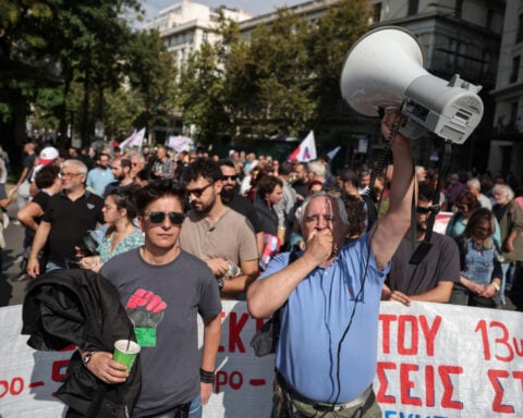 Greece adopts law extending working hours despite protests