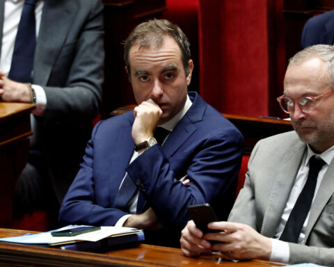 French PM faces fraught budget talks after surviving no-confidence votes