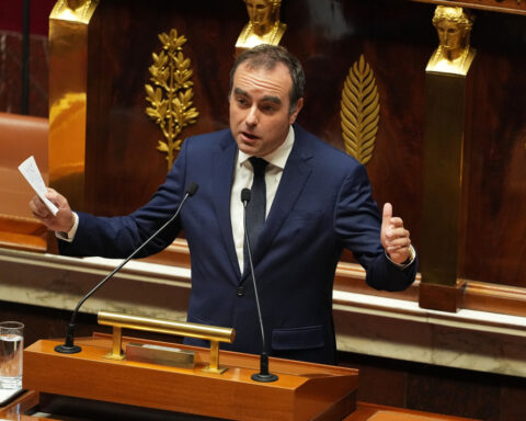 Political crisis in France eases for now as prime minister survives no-confidence vote