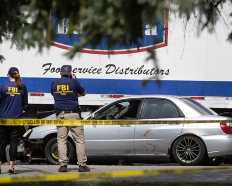 Federal agents detain a Chicago TV station employee