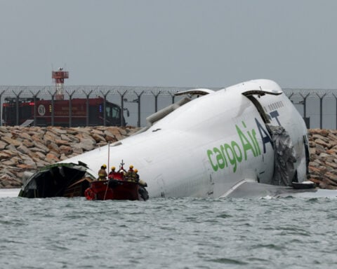 Cargo plane slides off runway in Hong Kong, killing two airport staff