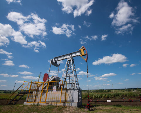 Oil settles at 5-month low as supply glut fears mount