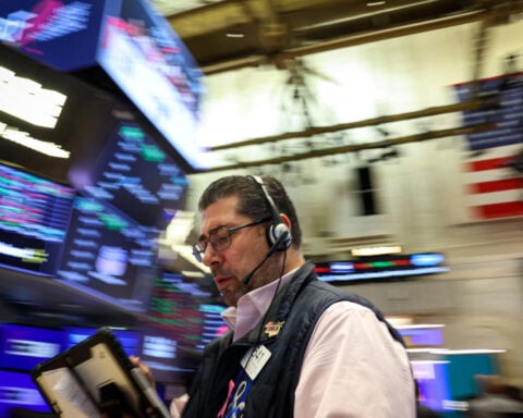 Wall Street ends mixed as earnings lift the Dow