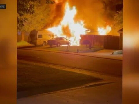 Flames engulf home's garage, video shows