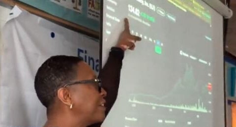 Retired stockbroker teaching students financial literacy