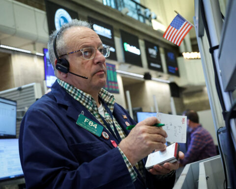 Wall Street notches record closing highs on cool inflation, solid earnings