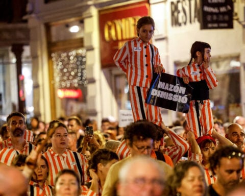 Protesters urge regional Spanish leader to quit a year after deadly floods