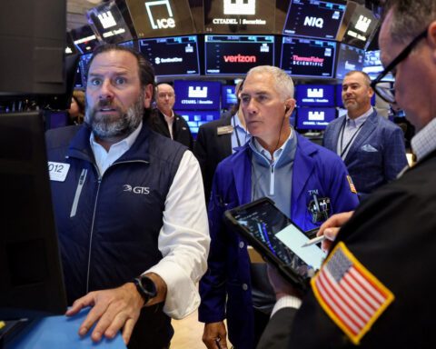 Wall St ends lower as bank CEOs warn of possible pullback, fueling tech bubble jitters