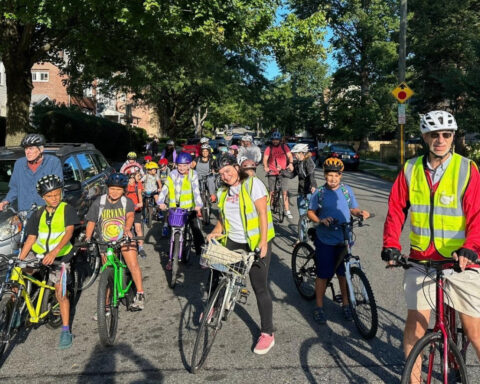 From a few to more than 350, children and parents ride together to school as a 'bike bus'