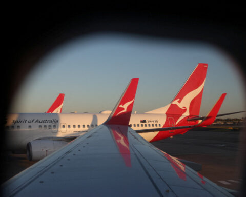 Qantas cuts first-half domestic revenue forecast, citing softer travel demand