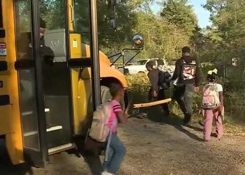 Students told to climb under train car at bus stop