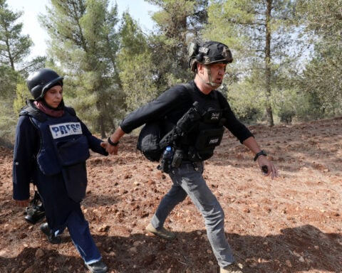 Israeli settlers attack Palestinians, journalists at West Bank olive harvest, witnesses say