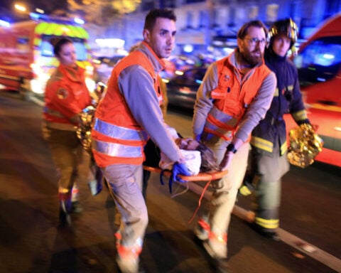 France honors victims 10 years after attacks at Bataclan concert hall, cafes and national stadium