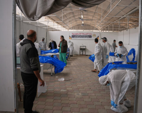 Israel returns 15 Palestinian bodies to Gaza, where displaced families endure winter rains