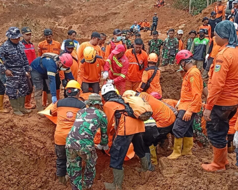 Indonesian rescuers search for nearly three dozen people after landslides killed at least 18 people