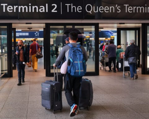 Net immigration to Britain revised down as more Britons emigrate