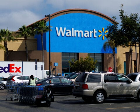 Walmart bumps up outlook ahead of holidays, plans listing switch to Nasdaq