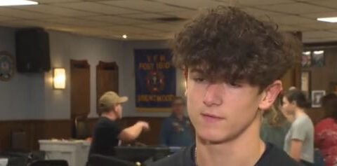 Teenager giving back to service members by stuffing stockings for sailors