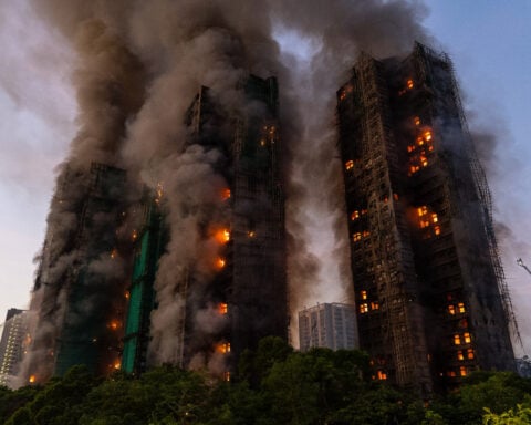Fire rages through bamboo scaffolding at Hong Kong high-rise residential complex, killing 4
