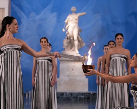 Under a cloud, the Olympic flame begins its journey to the Milan Cortina Winter Olympics