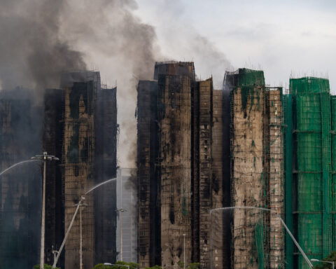 At least 94 dead as Hong Kong firefighters battle burning towers for a second day