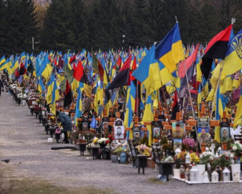 At crowded Ukrainian cemetery, mourners yearn for war to end