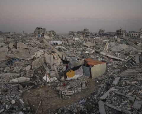 Israeli forces kill at least 13 people in southern Syria raid, officials and residents say