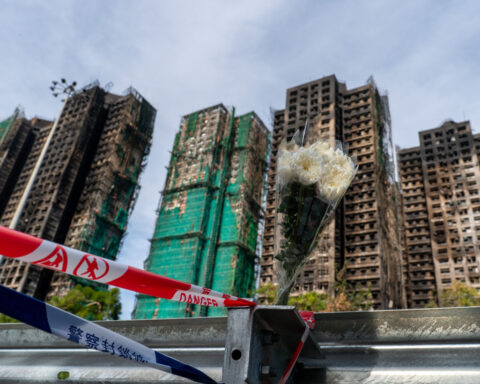 Eight more arrested over deadly Hong Kong blaze as toll rises to 128 with hundreds still missing