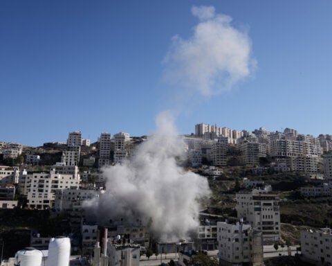 Israeli forensics experts examine remains handed over by militants in Gaza