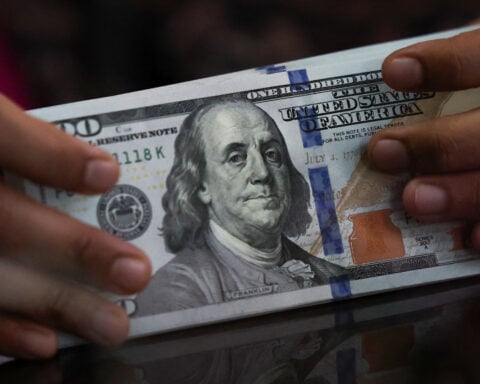 Dollar eases versus yen as BOJ hints at rate hike