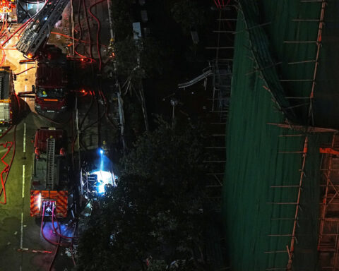 Mourners flock to site of deadly Hong Kong blaze as Beijing warns against protests