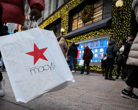 Macy's strikes cautious tone on holiday spending, posts surprise profit