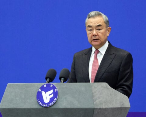 China's foreign minister urges France to support its position on Japan