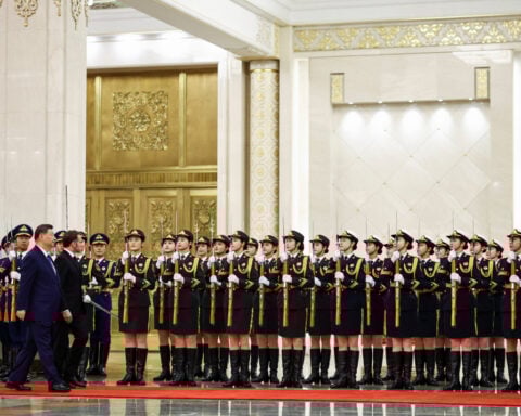 Flanked by business leaders, Macron meets Xi as EU prepares tougher trade rules