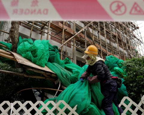 Hong Kong races to remove scaffolding nets blamed for fuelling deadly fire