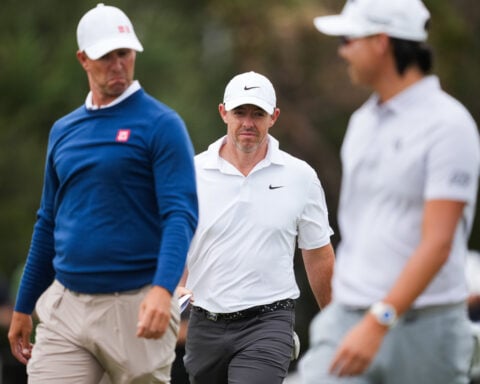 Rory McIlroy's late birdie burst means he'll be playing on the weekend at the Australian Open
