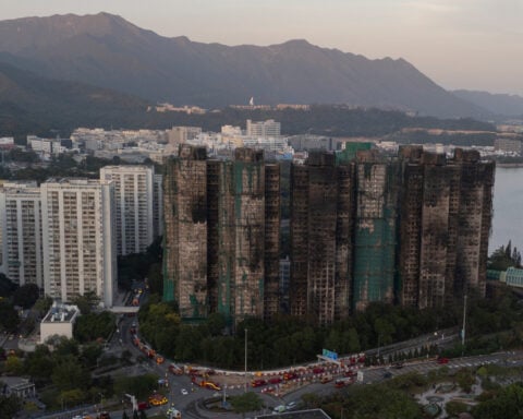 Hong Kong police arrest man for posts about deadly fire