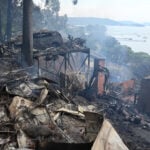 Wildfires destroy 40 homes and kill a firefighter in Australia