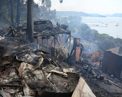Wildfires destroy 40 homes and kill a firefighter in Australia
