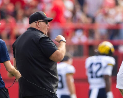 Biff Poggi tells signees and parents Michigan hopes to hire a coach by end of month, AP source says