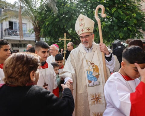‘We are still here.’ Catholic patriarch leads Christmas Mass at Gaza church bombed by Israel during the war