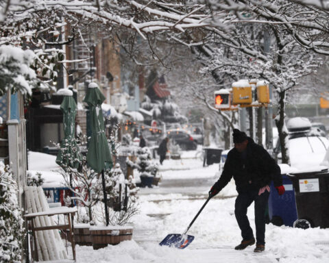 Blizzard conditions snarl holiday travel as tornadoes leave damage in the Midwest
