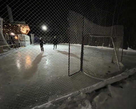 Instead of building snowmen, a local family builds a hockey rink in their backyard