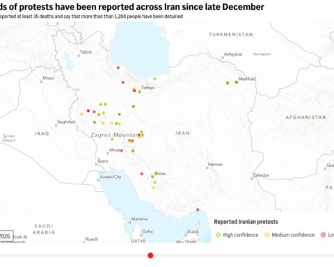 Security forces clash with protesters in Iran's main market as toll rises to 36
