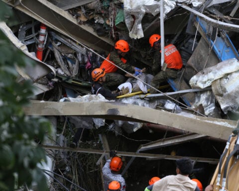 Mound of garbage collapses at Philippine landfill, killing 2 and leaving 36 others missing