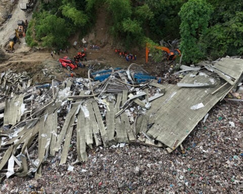 Filipino rescuers detect 'signs of life' in garbage avalanche that killed 4 and left dozens missing