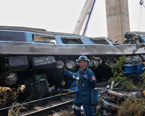 A construction crane falls onto a moving train in Thailand, killing at least 32 people