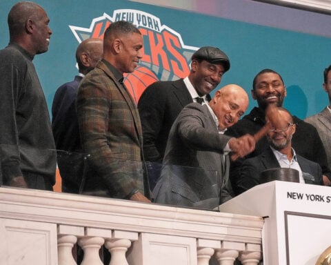 Stocks edge a bit below their latest records on Wall Street