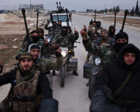 Kurdish forces retreat as government troops advance across northern Syria