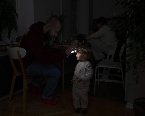 Bonfires, dancing, pets: How Ukrainians are staying warm during the toughest winter in years